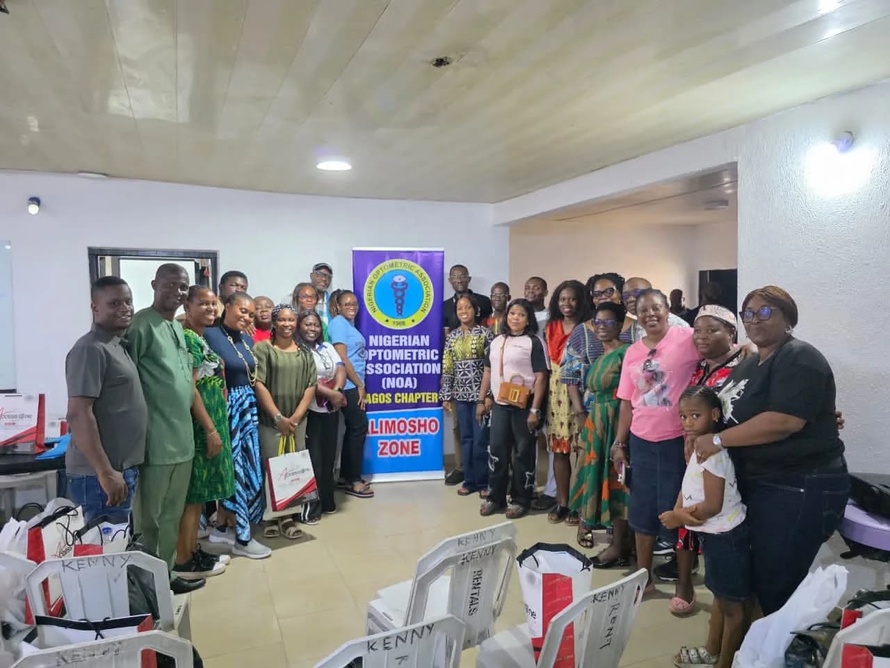 Members standing together beside a purple banner reading "Nigerian Optometric Association (NOA) Lagos Chapter — Alimosho Zone".