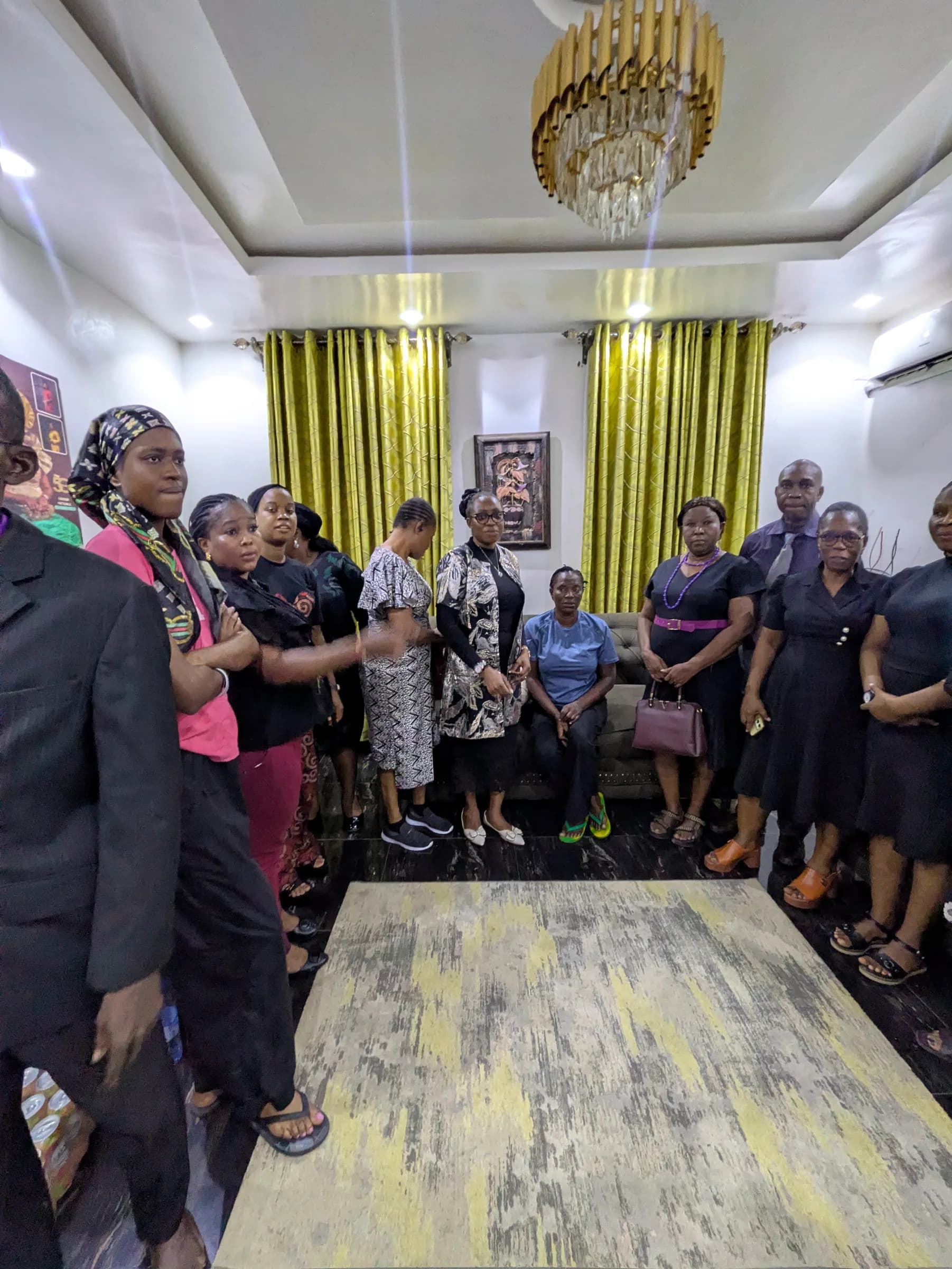 Members gathered in a room with seating around the walls.