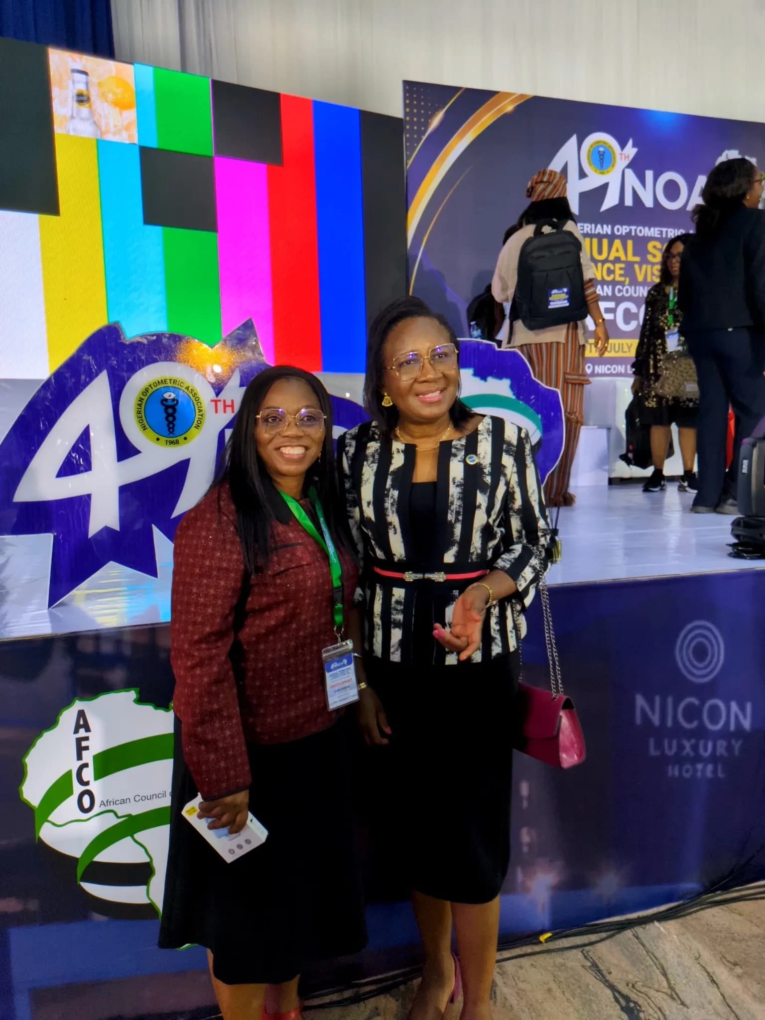 Two members photographed together in the conference foyer.