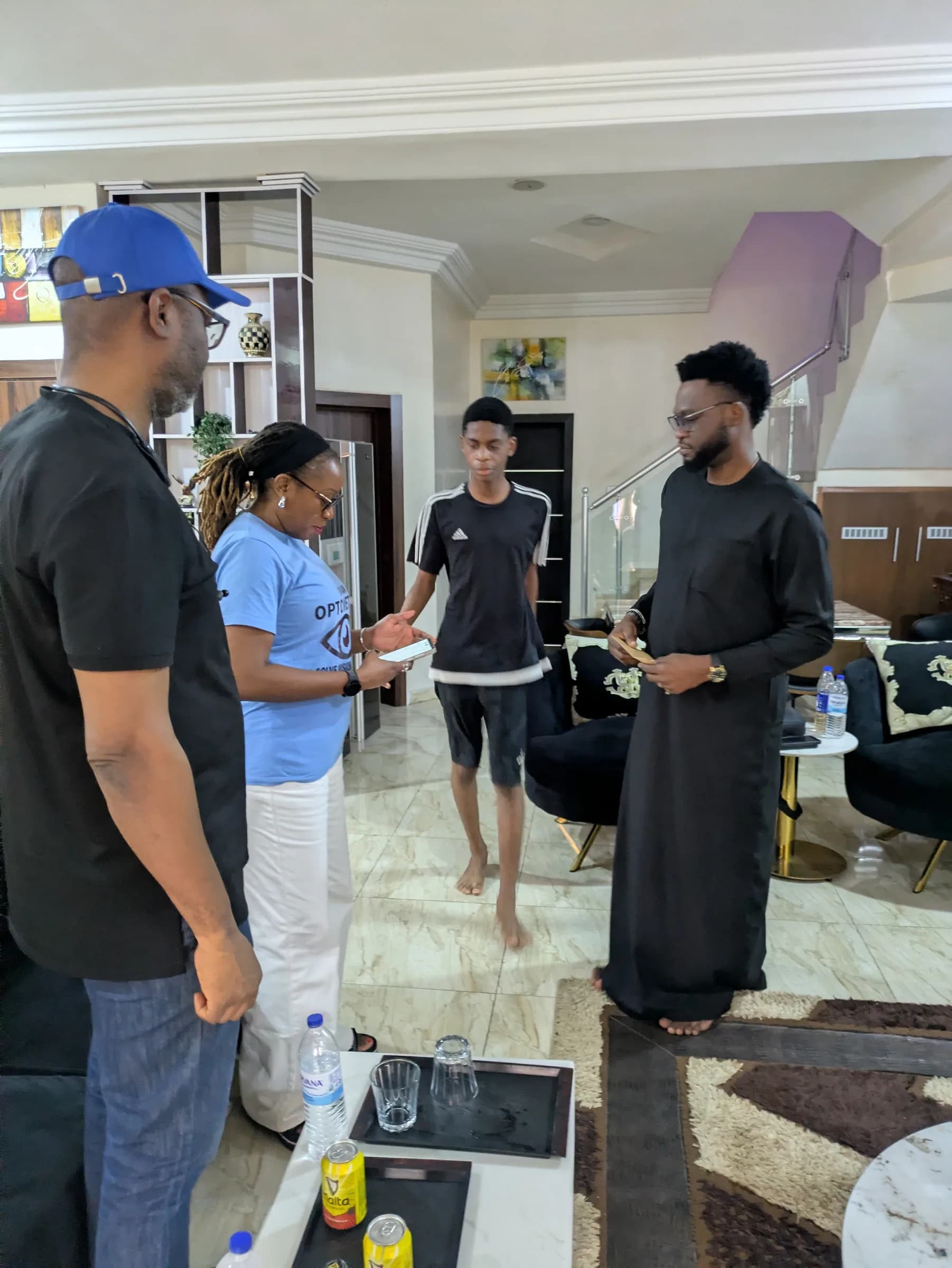 Members in NOA branded shirts attending to a young man during a screening.