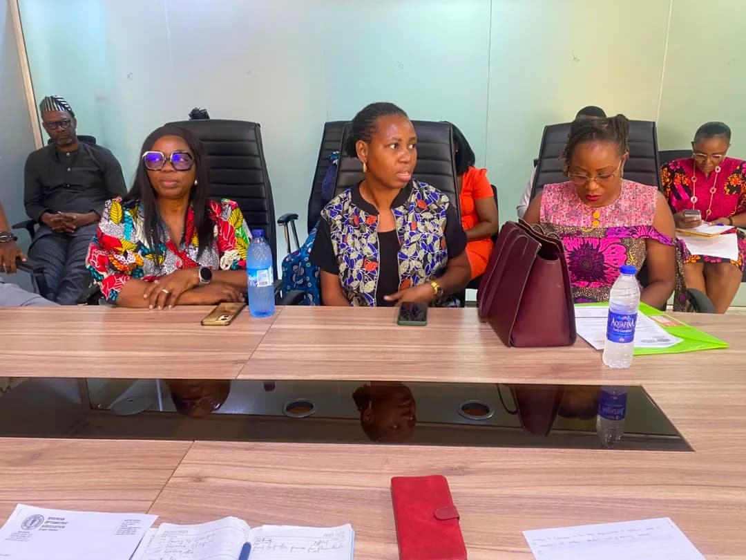 Members seated around a boardroom table during a zonal meeting.