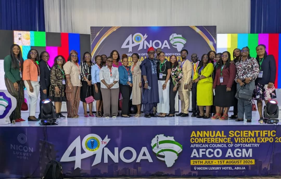 A large group photograph of delegates on stage in front of the 49th NOA conference banner.